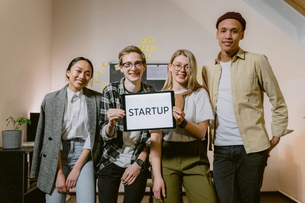 group of people holding startup picture 