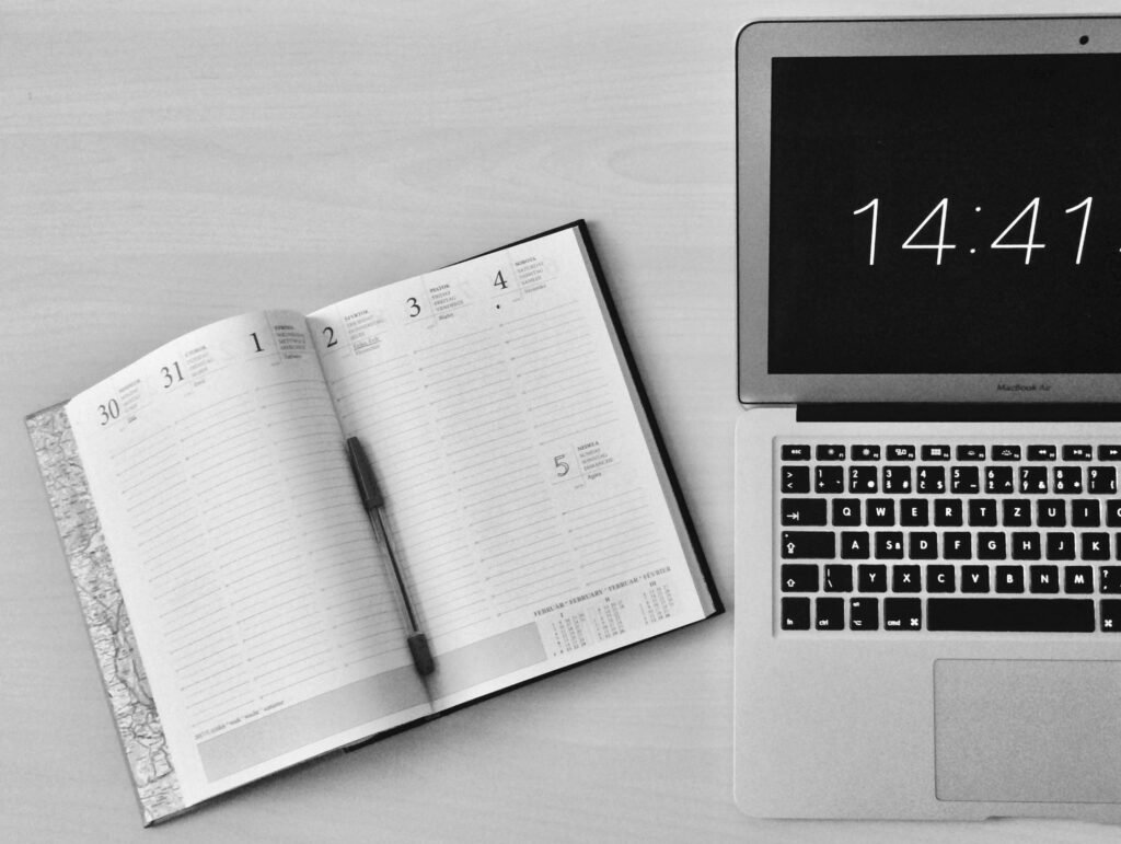 laptop and diary with pen