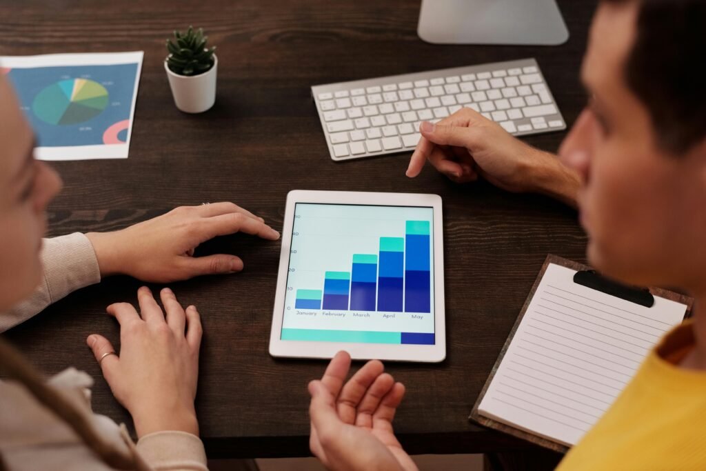 two SEO consultants analyzing graphs on IPAD