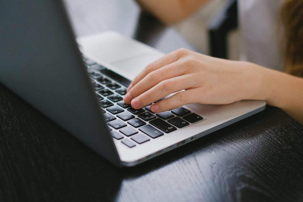 girl typing on laptop